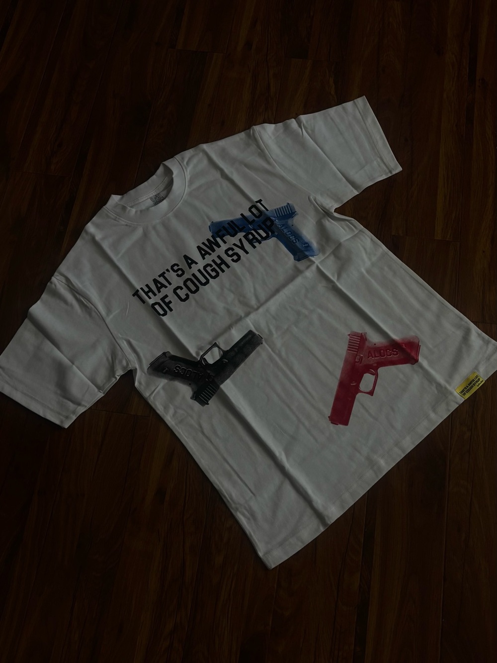ALOCS —-White Short-Sleeve Graphic Tee with Multicolor Gun Motifs
